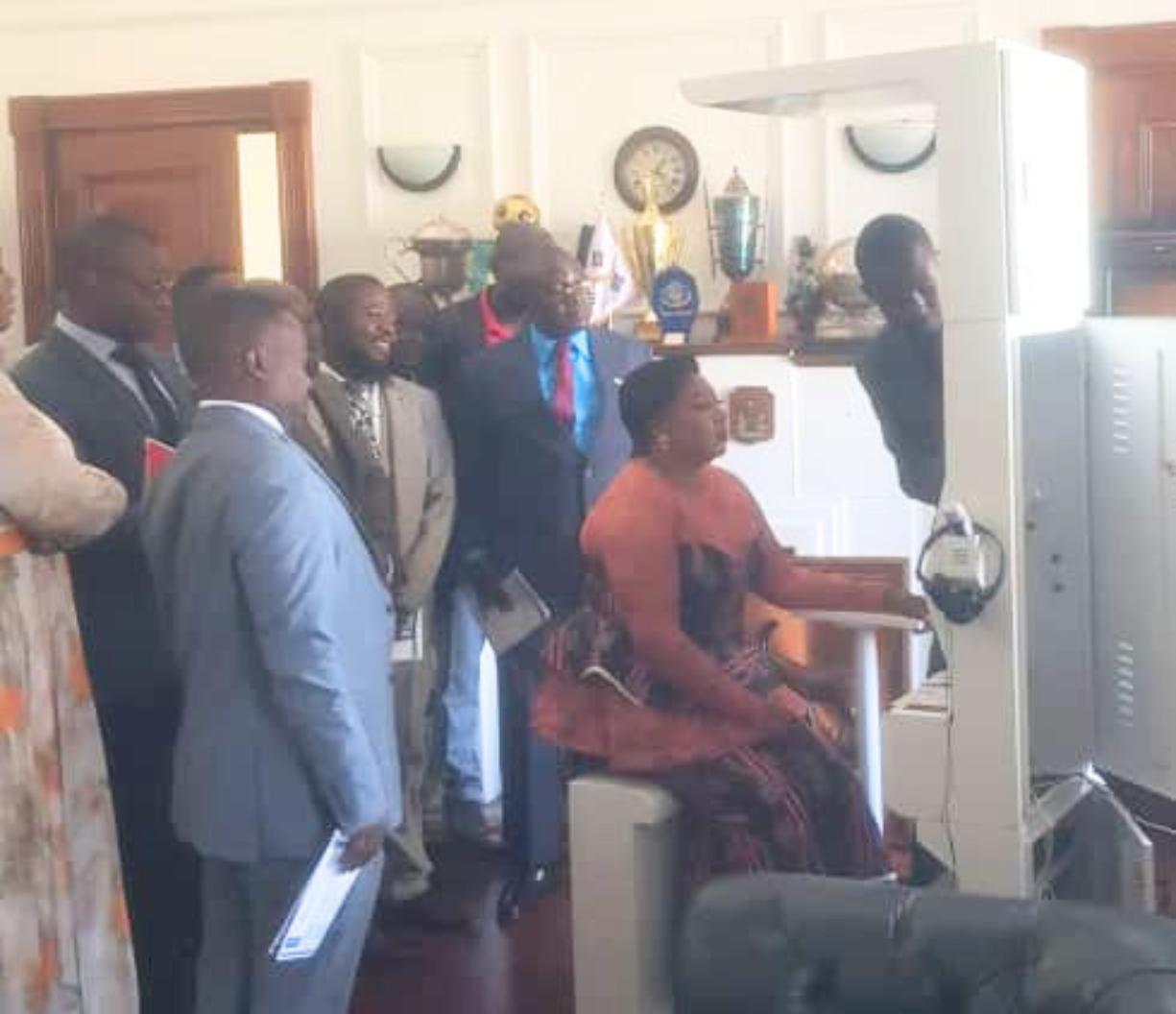 Health kiosk deployment in Africa, official demonstrating self-screening to community leaders